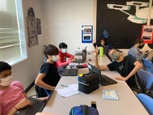 Students in the Journalism classroom work in their groups with mixed results.